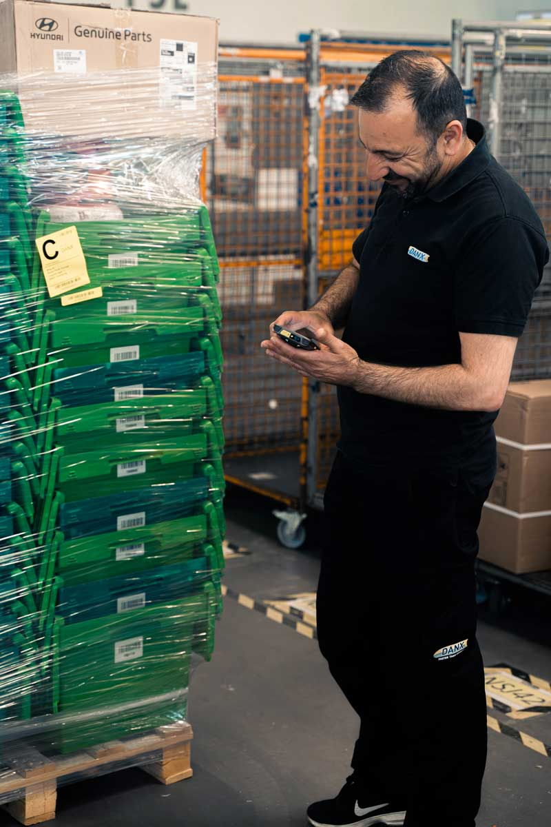 DANX employee uses the Newland MT95 Kambur Pro Mobile Computer Barcode Scanner at the Warehouse